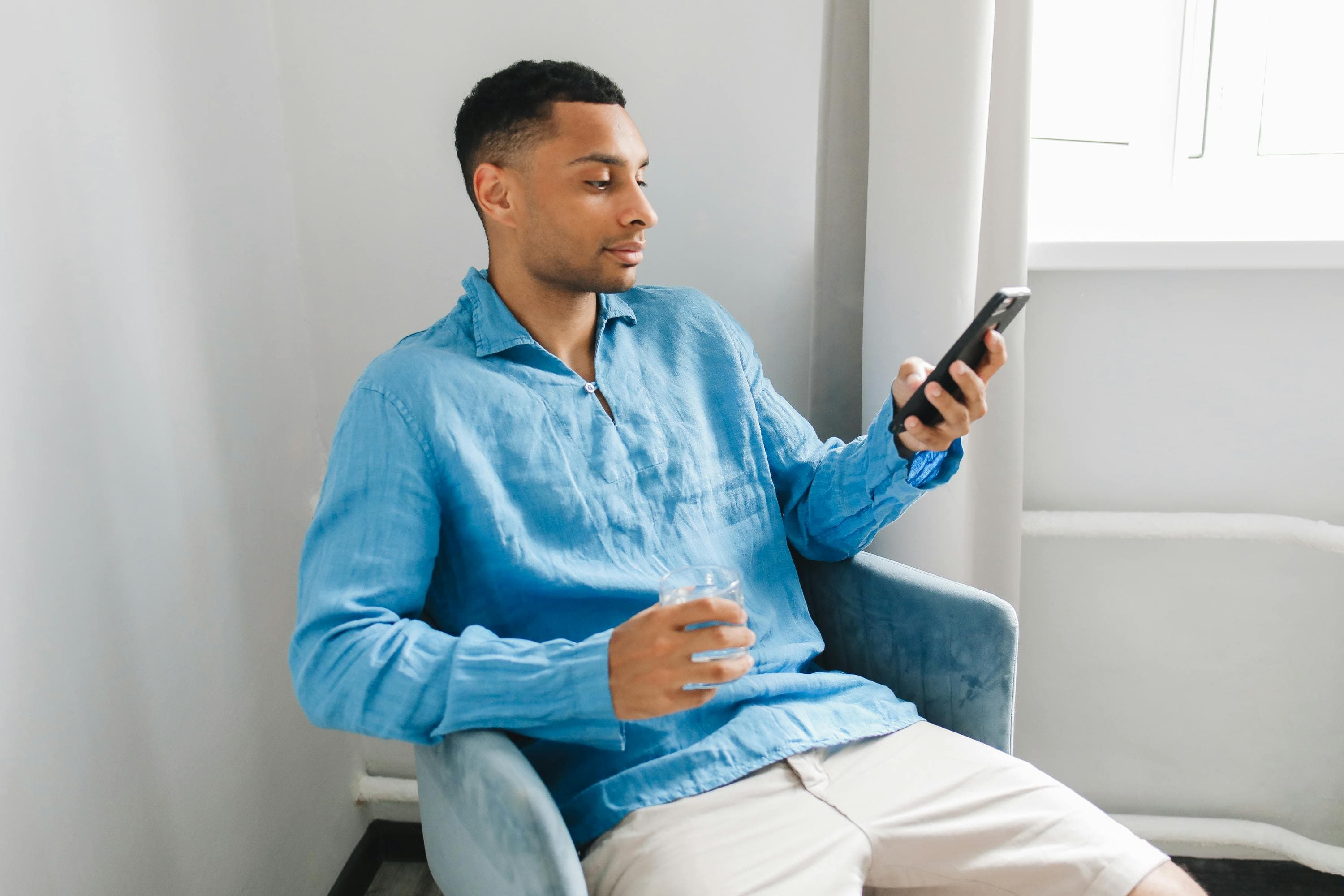 Man filling out form with open laptop.